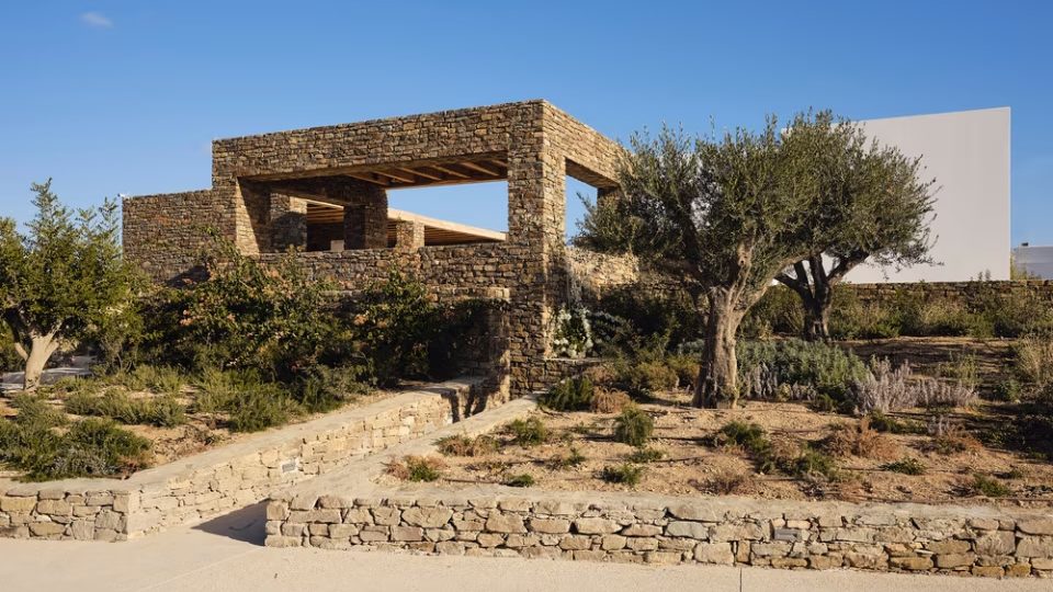 GREECE WATER, STONE, AND WHITE VOLUMES INTERACT WITH THE LANDSCAPE AND THE LIGHT